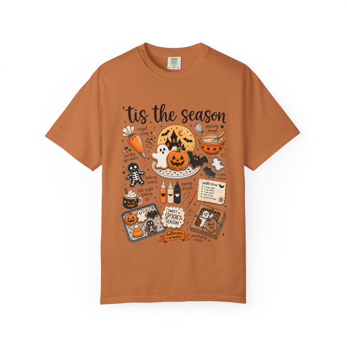 A rust-orange crewneck t-shirt featuring a detailed Halloween-themed graphic print with illustrations of jack-o'-lanterns, ghosts, a spider, a cauldron, and spooky text reading 'tis the season' and 'Halloween Spooktacular'.