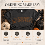 A promotional graphic for a dark charcoal gray embroidered t-shirt with 'MOMSTER' in orange outlined letters. The shirt is styled with autumn props like pumpkins, black lace, and a spider on a beige background with 'ORDERING MADE EASY' text and four step-by-step ordering icons below.