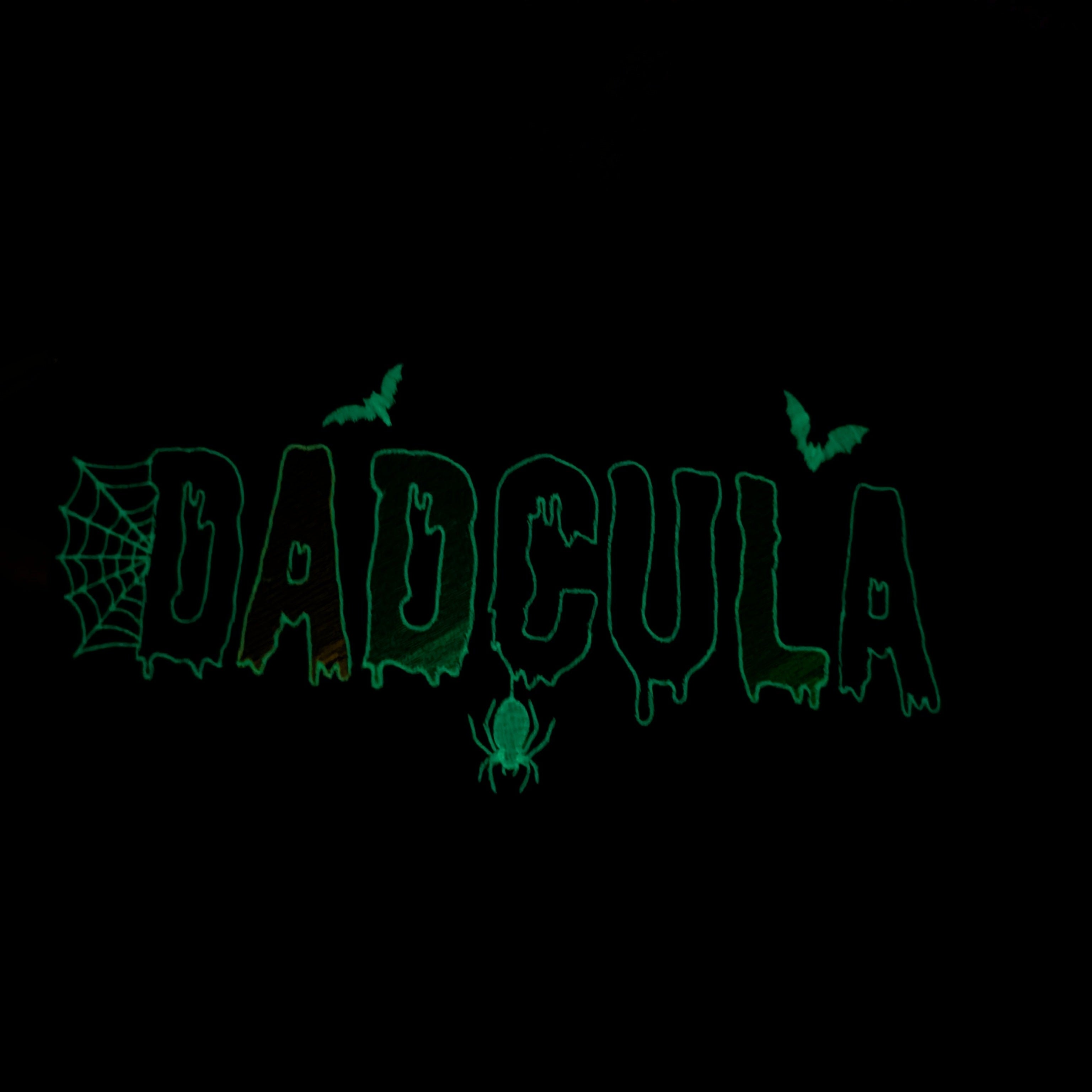 A black background with a vertically oriented green glowing outline graphic that appears to spell 'BADGUYS' with spider and bat motifs.